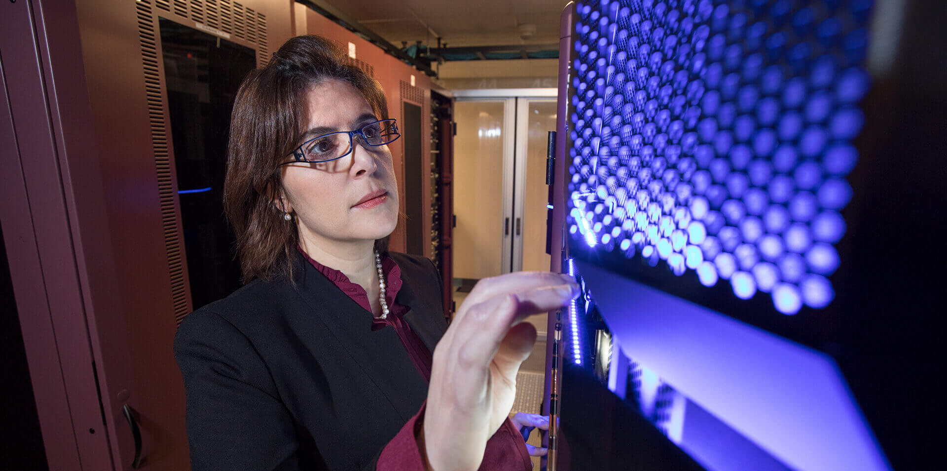 Business woman inspecting computer banks