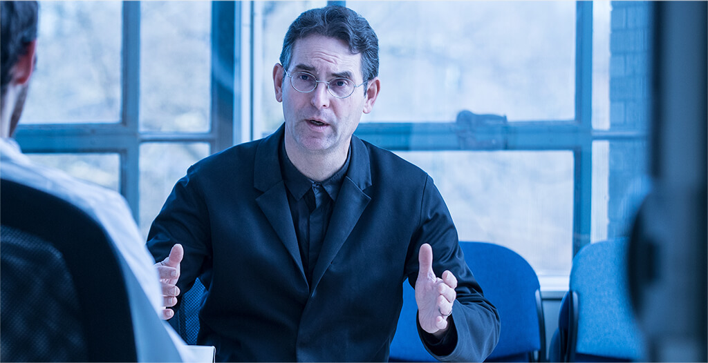 John D. Halamka, M.D. in business meeting